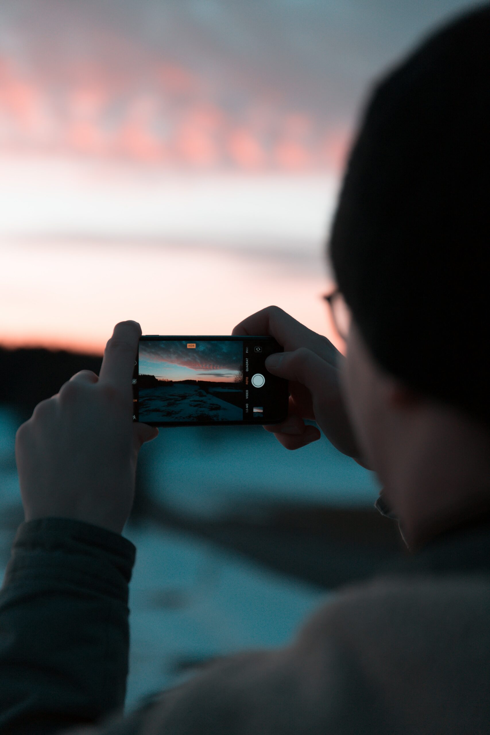 jonny-caspari-DZBsW0ubjBY-unsplash Man takeing photo with mobile phone with sunset