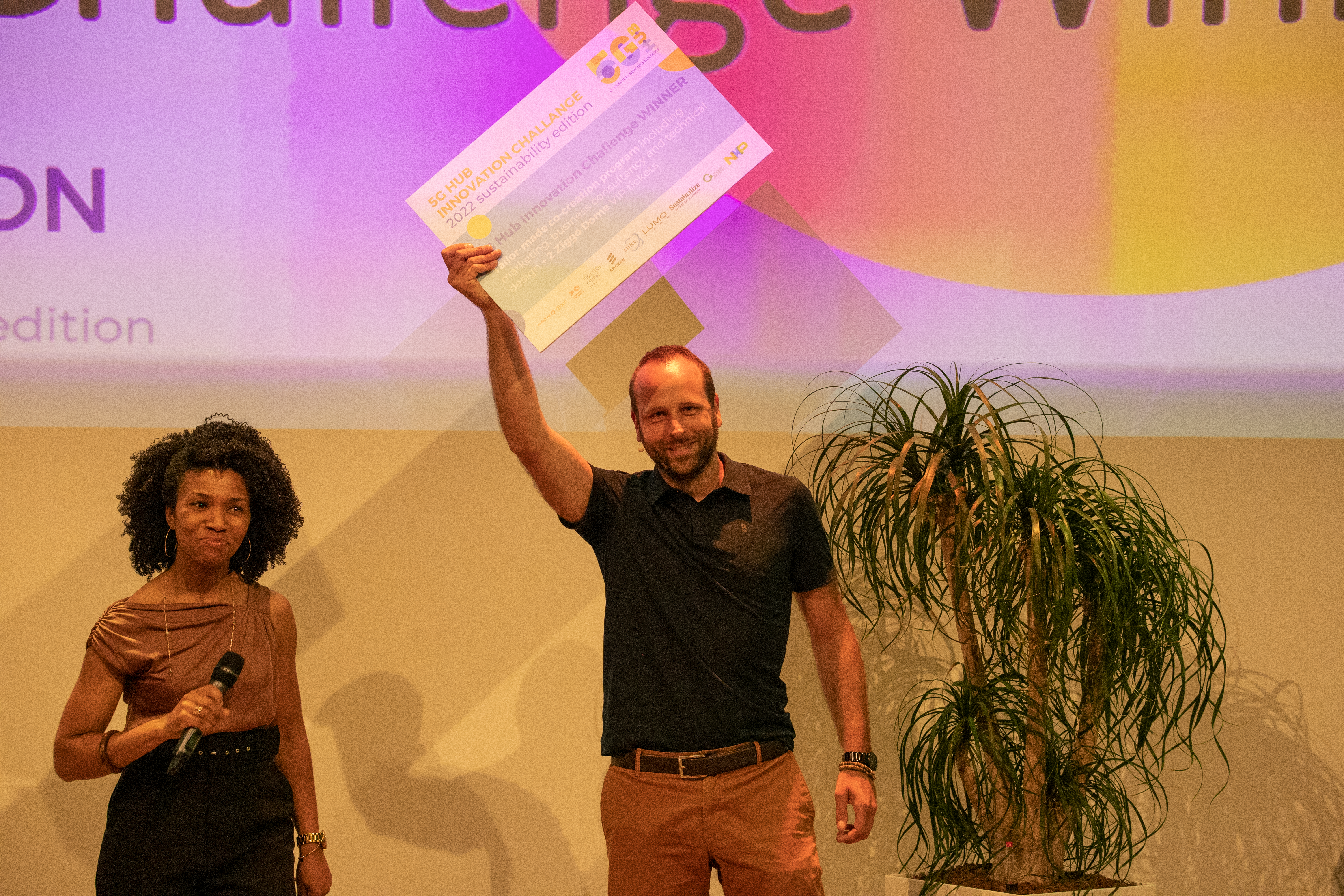 Tech Innovation winner Winner of competition holds up card