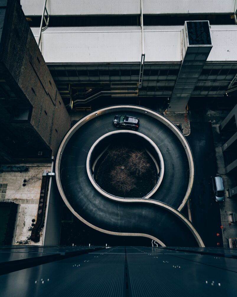 An aerial view of a parking garage ramp spiraling upwards